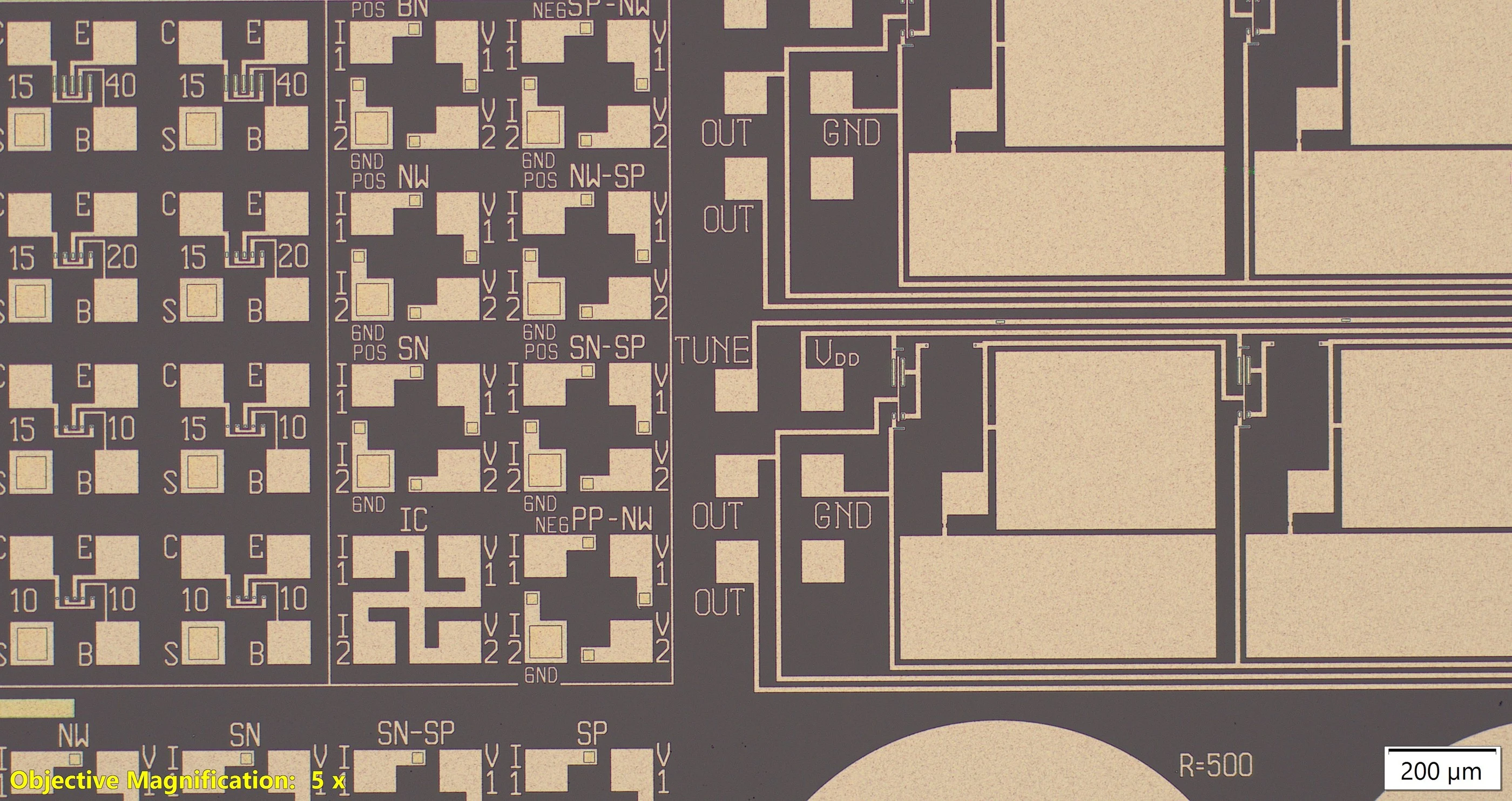 Optical micrograph of the dry-etched die: aluminium on brown field oxide, an array of labelled Van der Pauw structures (NW, SN, SP, IC, PP-NW) beside bipolar test devices and oscillator pads