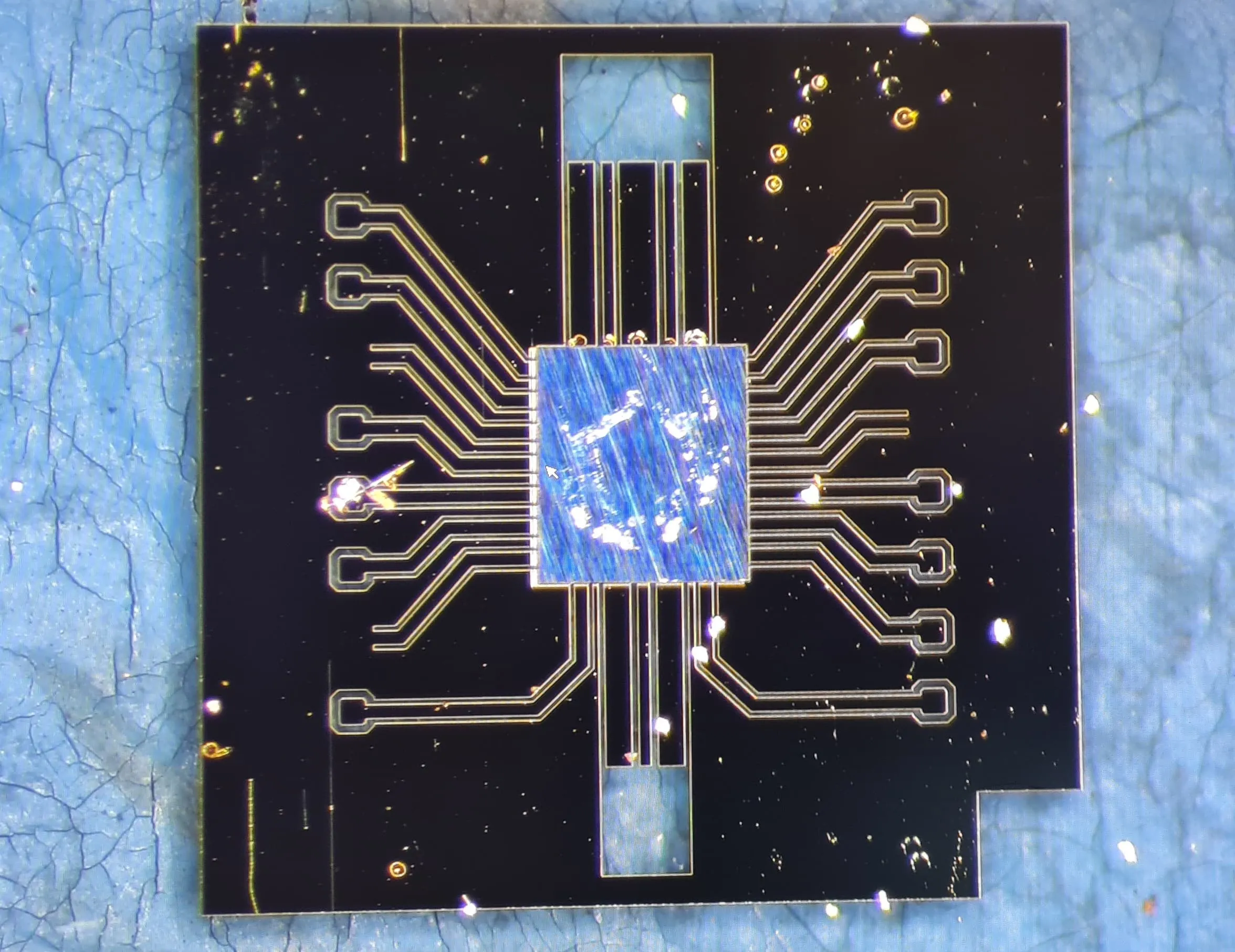 Close-up photograph of a thin RF die bonded face-down onto a glass interposer