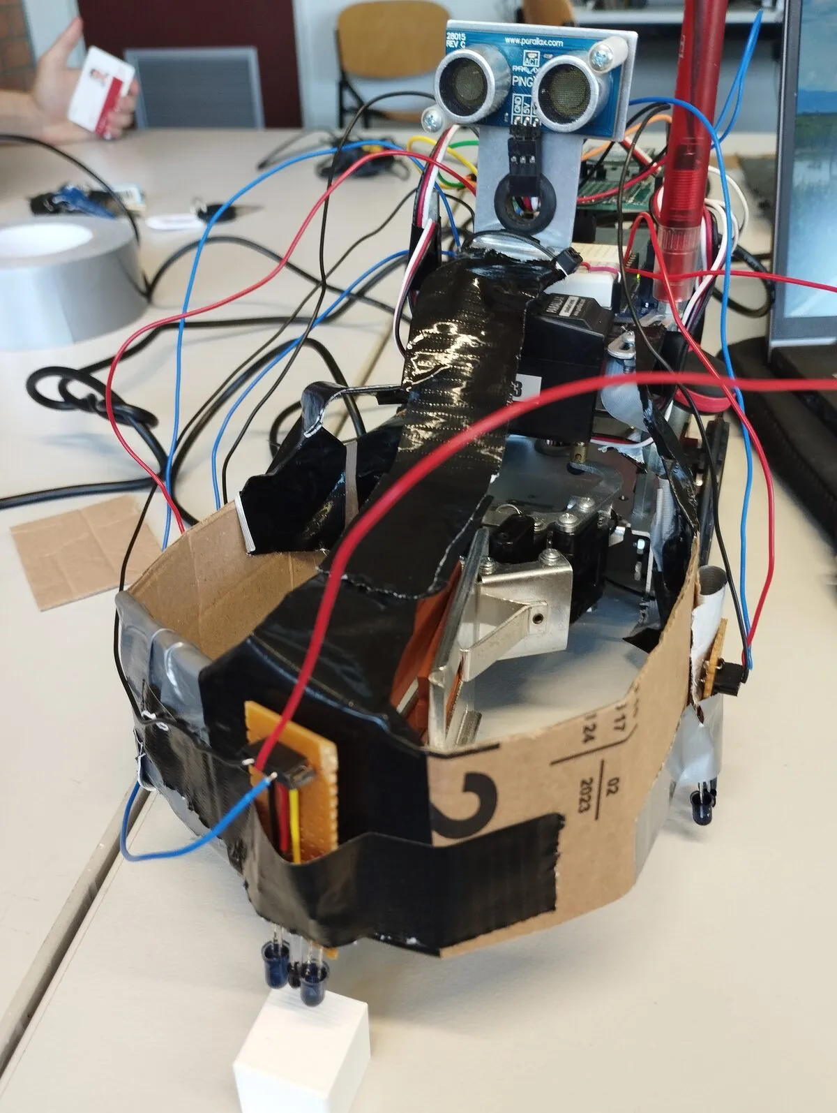 The assembled rover with its servo-mounted ultrasonic sensor, floor-facing infrared sensors and gripper